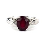 A 9ct white gold ring set oval red coloured stone and two small diamonds, ring size S, 2.