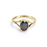 A 9ct yellow gold ring set oval facet cut obsidian, Birmingham 1977, ring size O 1/2, 1.