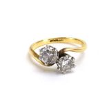 An 18ct yellow gold crossover ring set two brilliant cut diamonds, stones approximately 0.