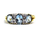 A 19th century-style 18ct yellow gold ring set three graduated aquamarine interspersed with four