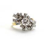 An 18ct yellow gold cocktail ring of prunt design set brilliant cut diamonds in a tiered setting,