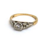 An early 20th century 18ct yellow gold ring set small brilliant cut diamond in an illusion setting,