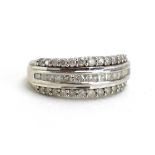A 9ct white gold ring set three bands of princess and brilliant cut diamonds,