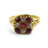 An early 20th century 18ct yellow gold cluster ring set four small diamonds and five red stones,