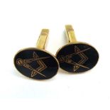 A pair of 9ct yellow gold cufflink's decorated in black enamel with the Masonic set square and