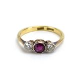 An early 20th century 18ct yellow gold and platinum highlighted ring set round cut ruby and two