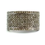 An 18ct white gold band ring set eight rows of small diamonds, ring size O 1/2, 8.