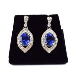 A pair of 14ct white gold ear pendants, each set oval tanzanite in a border of small diamonds, l. 2.
