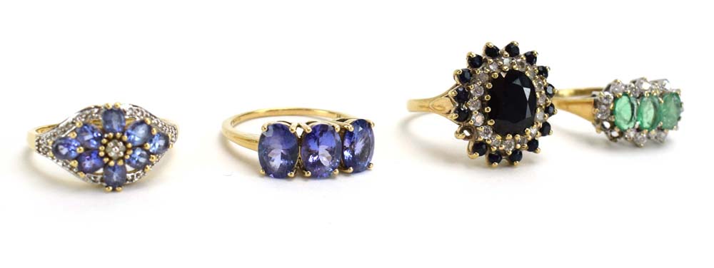 A 9ct yellow gold dress ring set pale blue stones and small diamonds in a flowerhead setting,