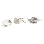 A modern 18ct white gold brooch in the form of a pair of leaves set small diamonds and emeralds, w.