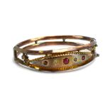 An Edwardian 9ct yellow gold openwork bracelet set red glass and two small diamond chips, maker T&C,