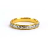 A 22ct two colour gold wedding band with engraved foliate decoration, London 1989, ring size O, 4.