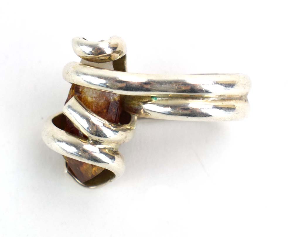 A late 20th century silver dress ring set amber coloured quartz within an entwined setting, - Image 3 of 7