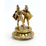 A silver gilt watch fob modelled as a pair of fighting knights, maker AJ, London 1962, l. 3.
