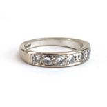 An 18ct white gold half eternity ring set seven slightly graduated brilliant cut diamonds,