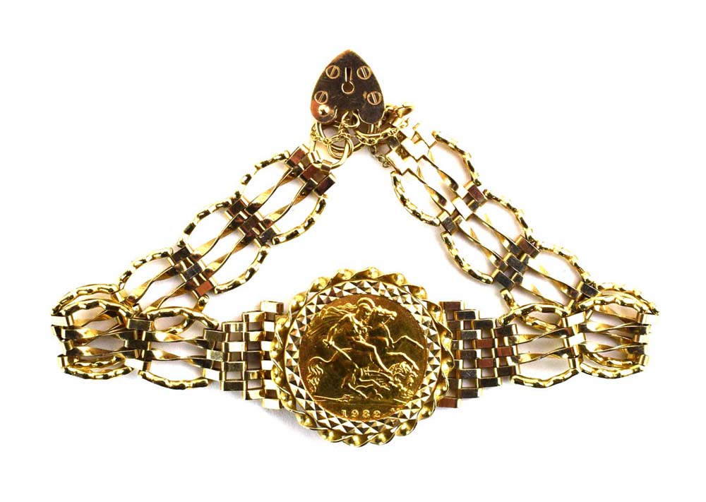 A 9ct yellow gold four bar gatelink bracelet set half sovereign dated 1982 in a loose mount,