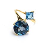 A 10ct yellow gold ring set brilliant and square cut Swiss blue topaz,