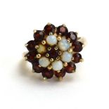 A 9ct yellow gold cluster ring set opals and garnets, ring size J 1/2, 5.