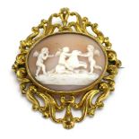 A 19th century yellow metal cameo brooch of oval form depicting putti at play within an openwork