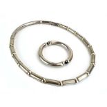 A late 20th century silver necklace having tubular sections on an expanding strap, maker Va,