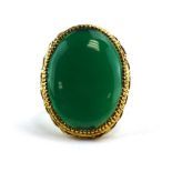 A 9ct yellow gold dress ring set oval green coloured stone, ring size T, 7.