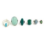 Five silver and metalware dress rings, each set green coloured stones,