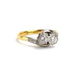 An early 20th century 18ct yellow gold and platinum highlighted crossover ring set two brilliant