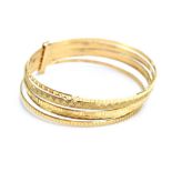 A 9ct yellow gold seven band bangle, each with different engraved decoration, maker LJI,