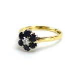 An 18ct yellow gold cluster ring set brilliant cut diamond and six sapphires, London 1967,
