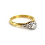 An 18ct yellow gold ring set brilliant cut diamond in a raised setting,