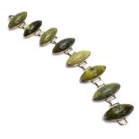 A silver bracelet of modern design set eight cabochon oval (?)New Zealand green stone, l.