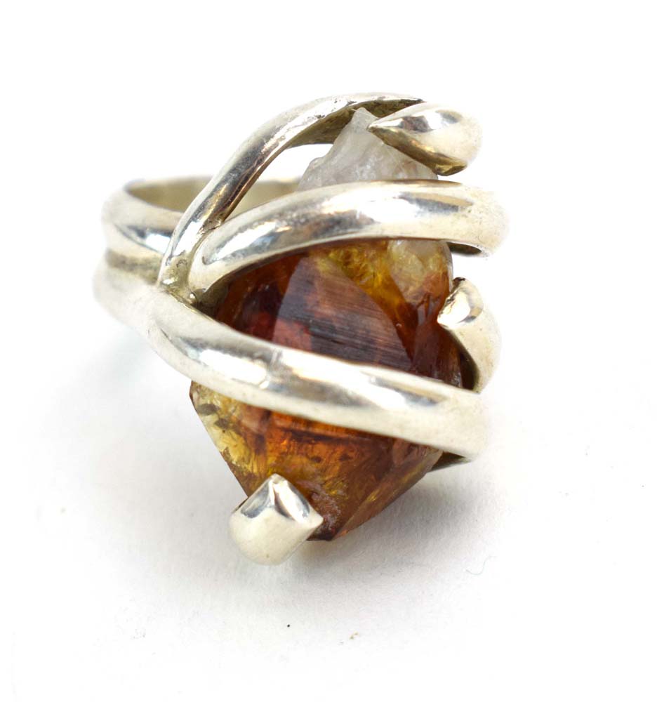 A late 20th century silver dress ring set amber coloured quartz within an entwined setting, - Image 2 of 7