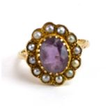 An early/mid 20th century 9ct yellow gold cluster ring set oval amethyst within a border of twelve