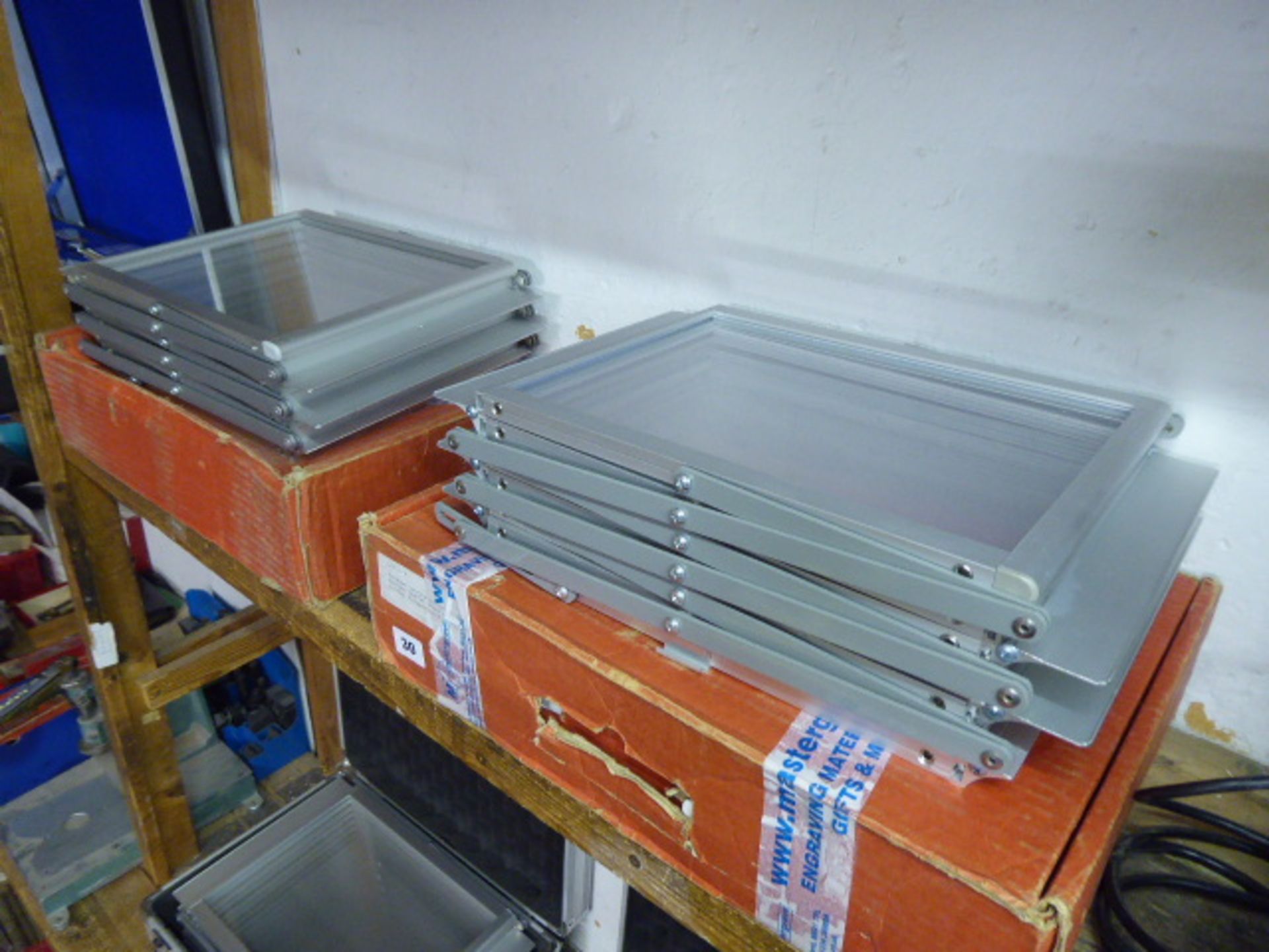 Two folding exhibition leaflet stands in cardboard boxes