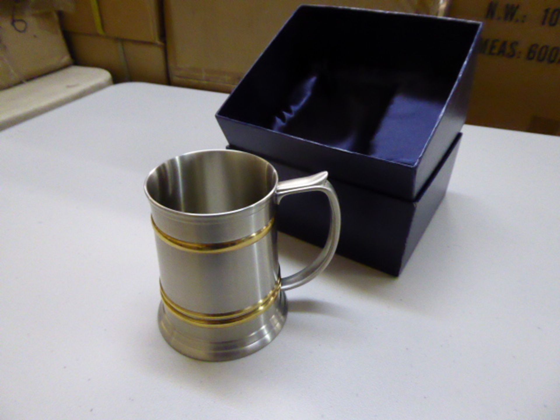 24 pewter tankards with brass colour detail