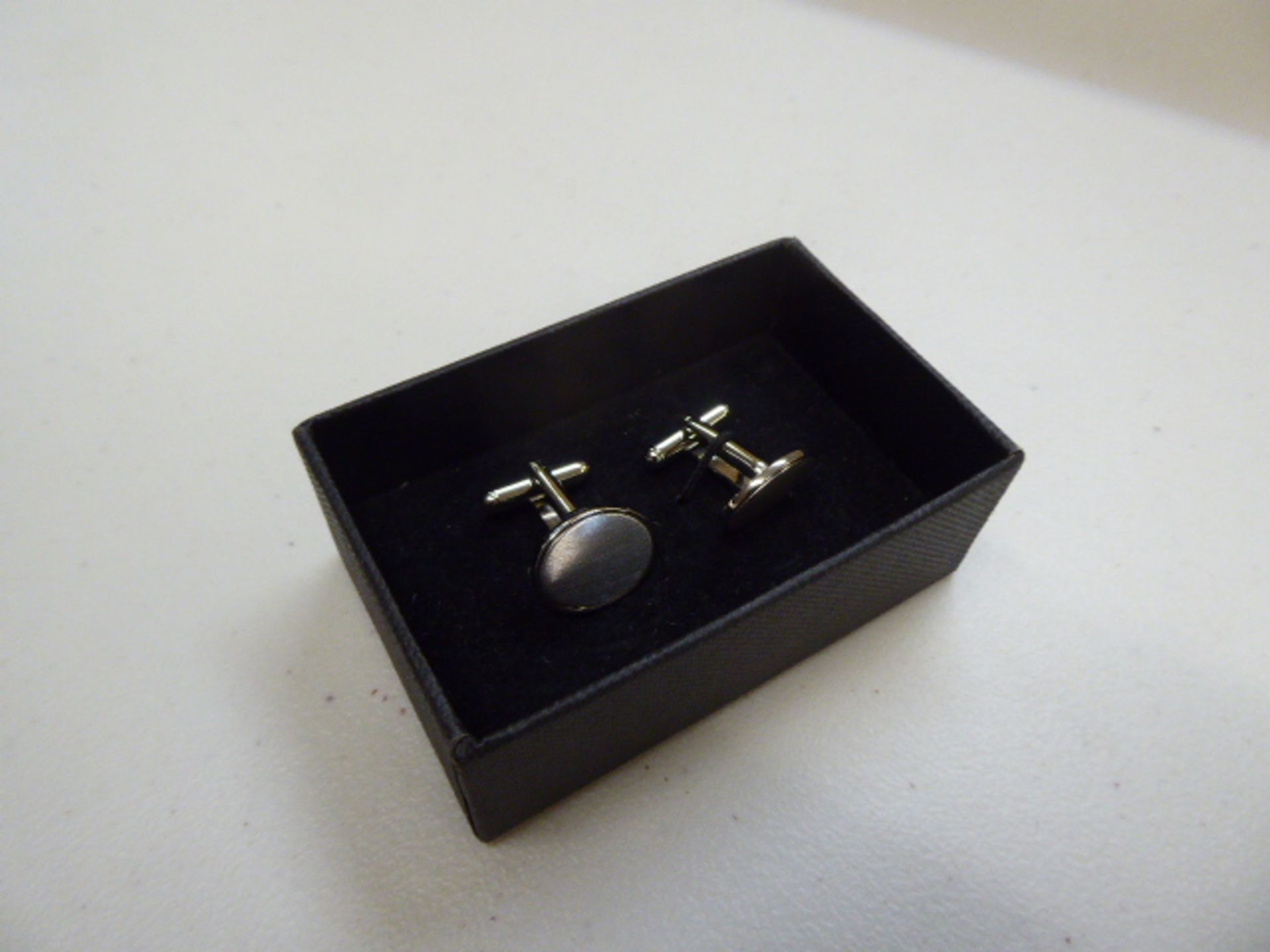 Approximately 900 oval cufflinks in presentation boxes
