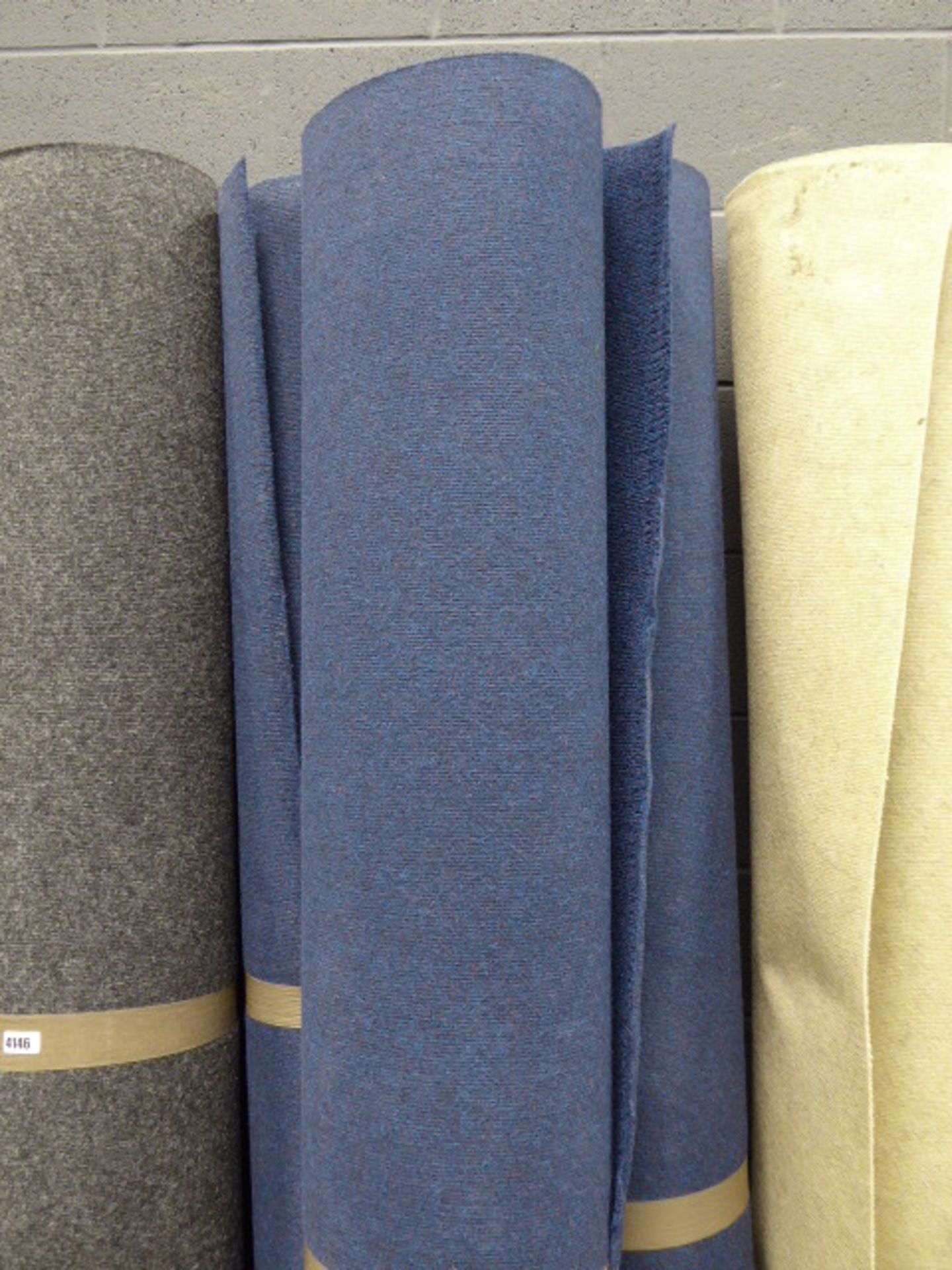 3 blue rolls of commercial style carpet