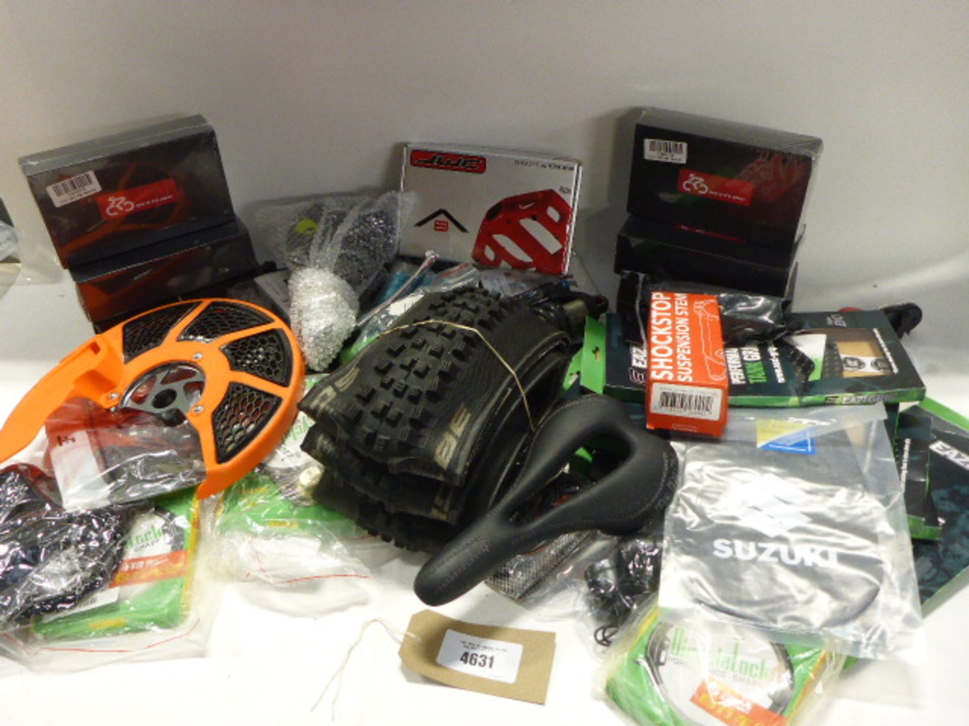 Bag containing bike suspension stem, seats, tyres, locks, pedals, brake levers, and boxed lights