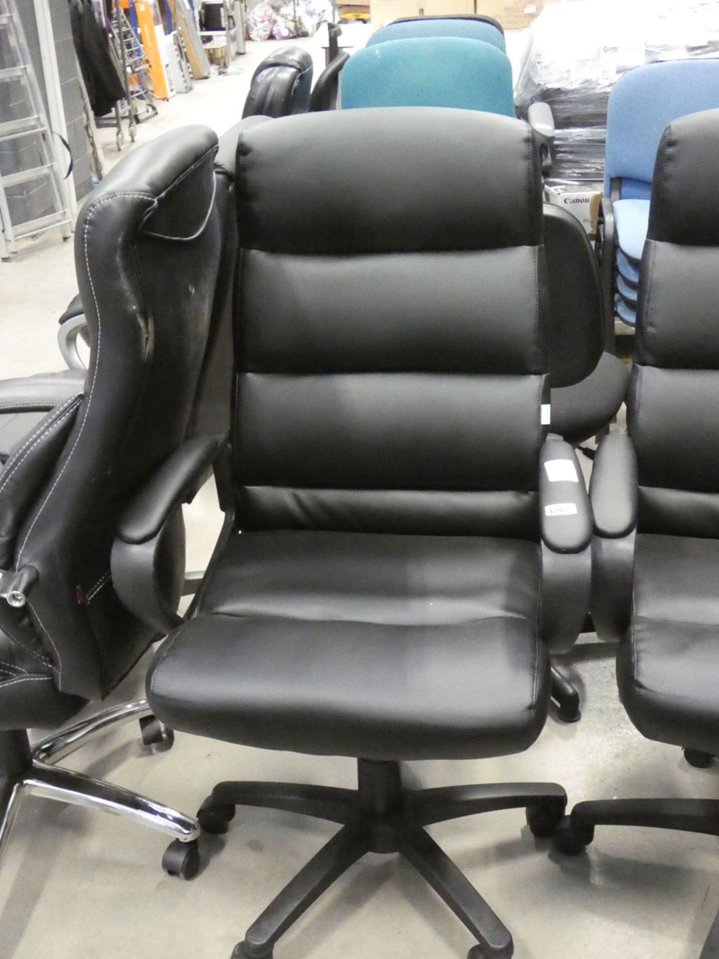 A black high back swivel armchair