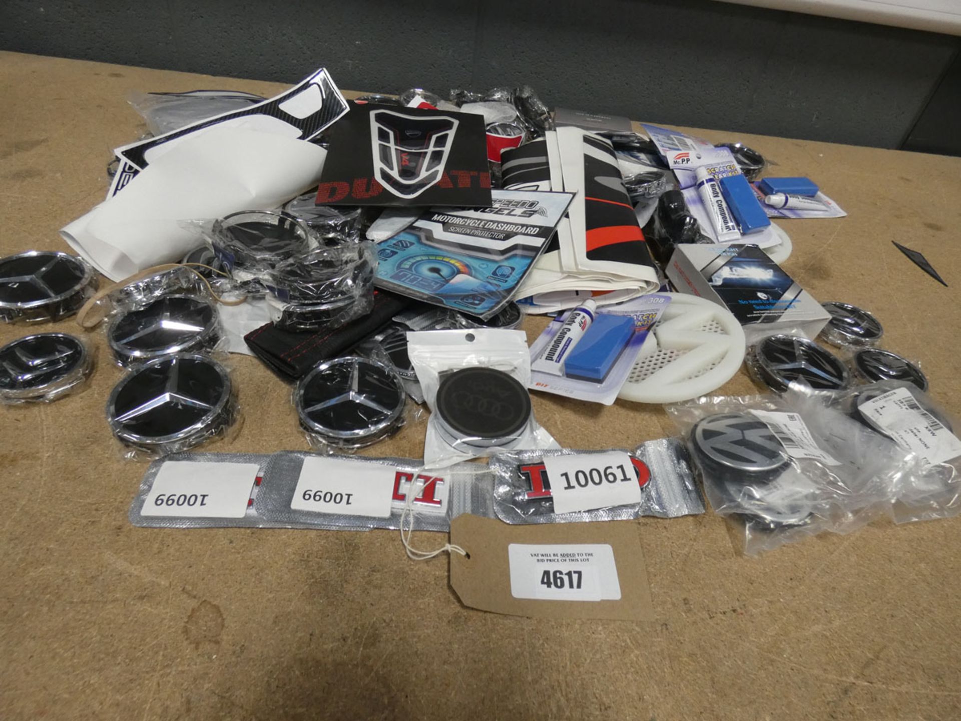 Bag of car badges and graphics including GTI Volkswagen, Mercedes, Citroen and other makes