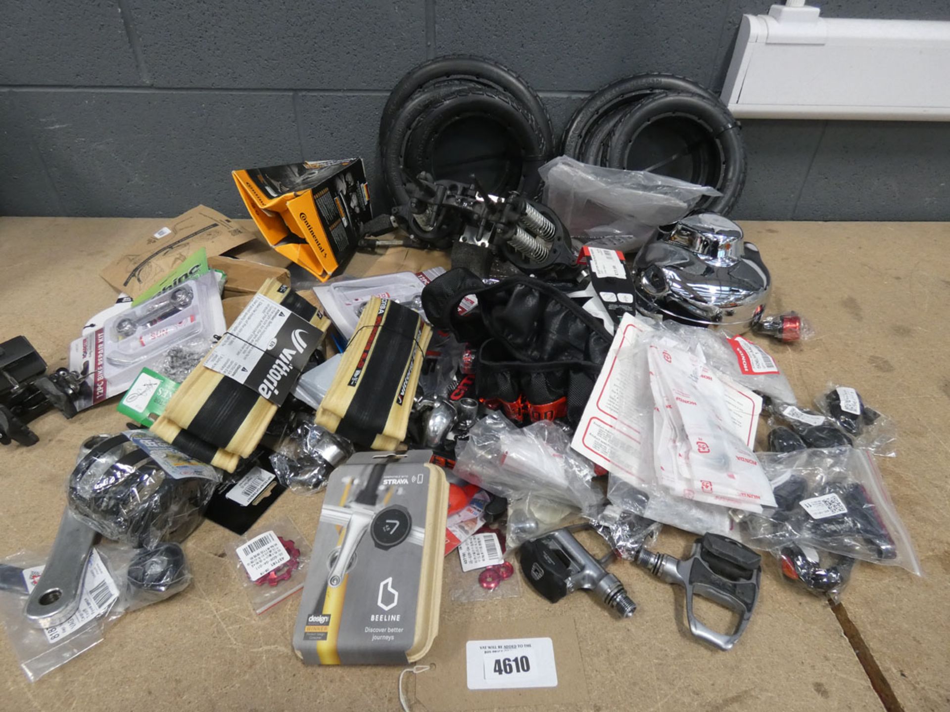 Bag containing motorbike parts including seat suspension, tyres, breaks, pedal shafts, cleats,