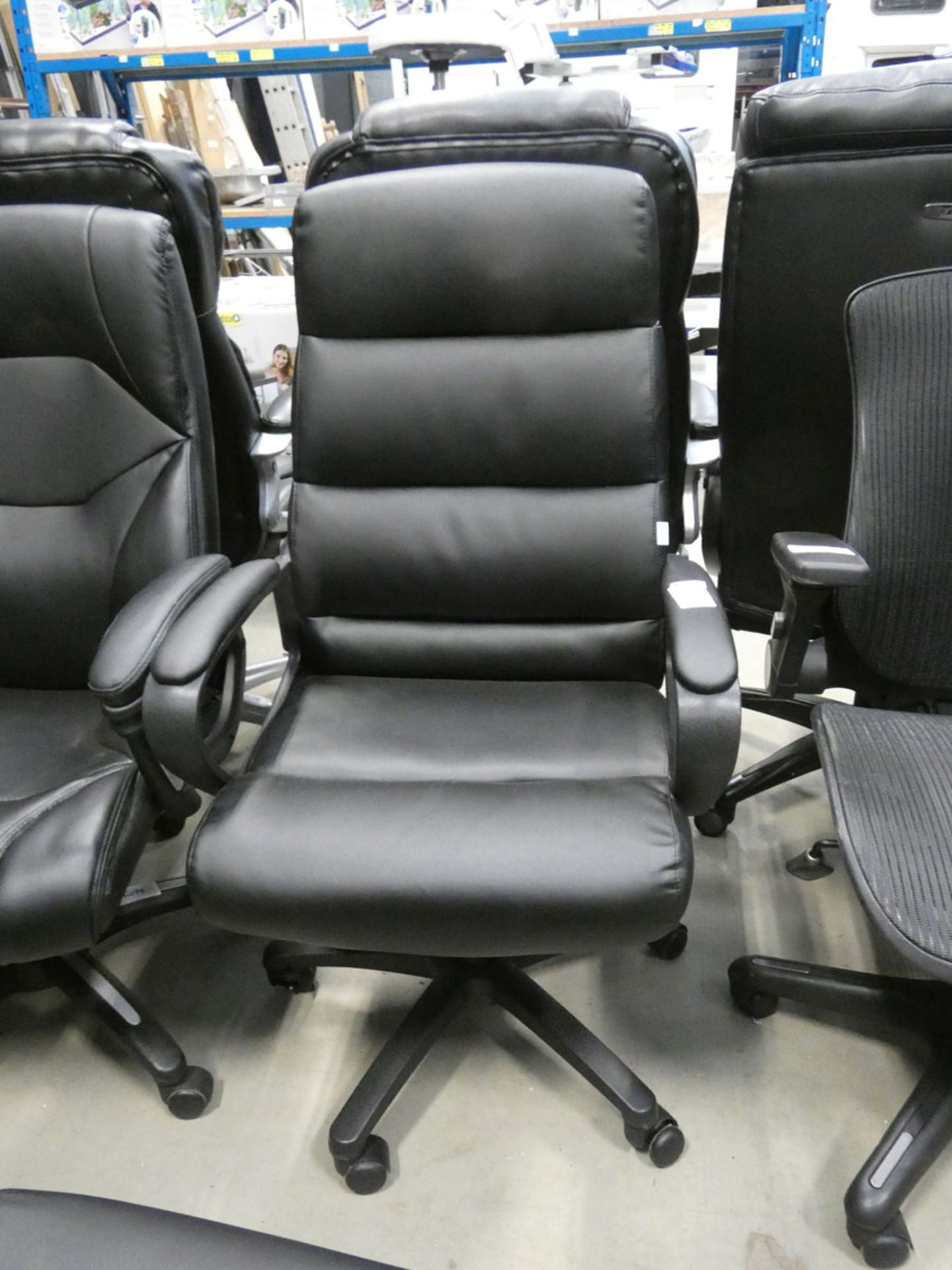 A black high back swivel armchair