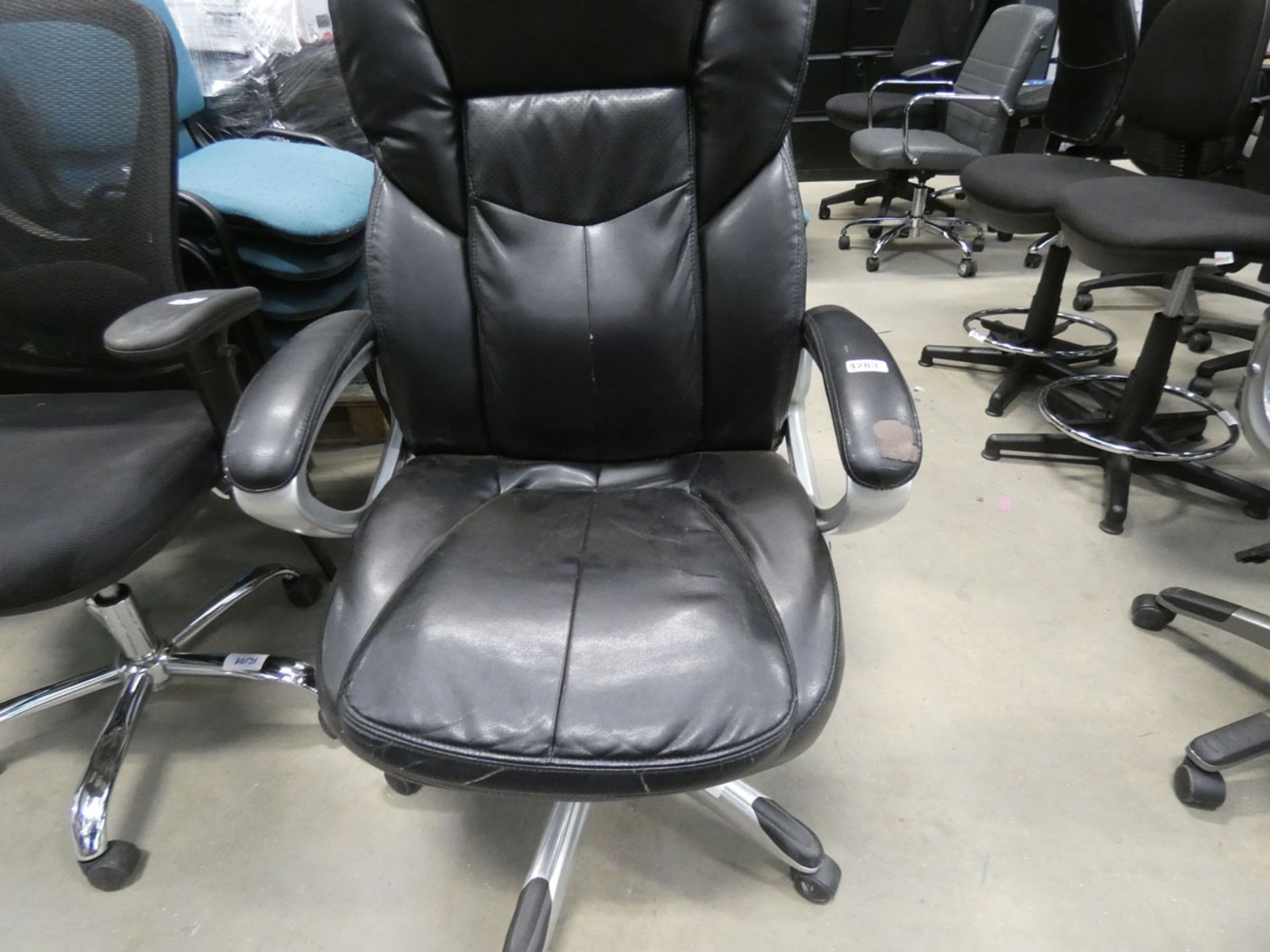 A black swivel armchair