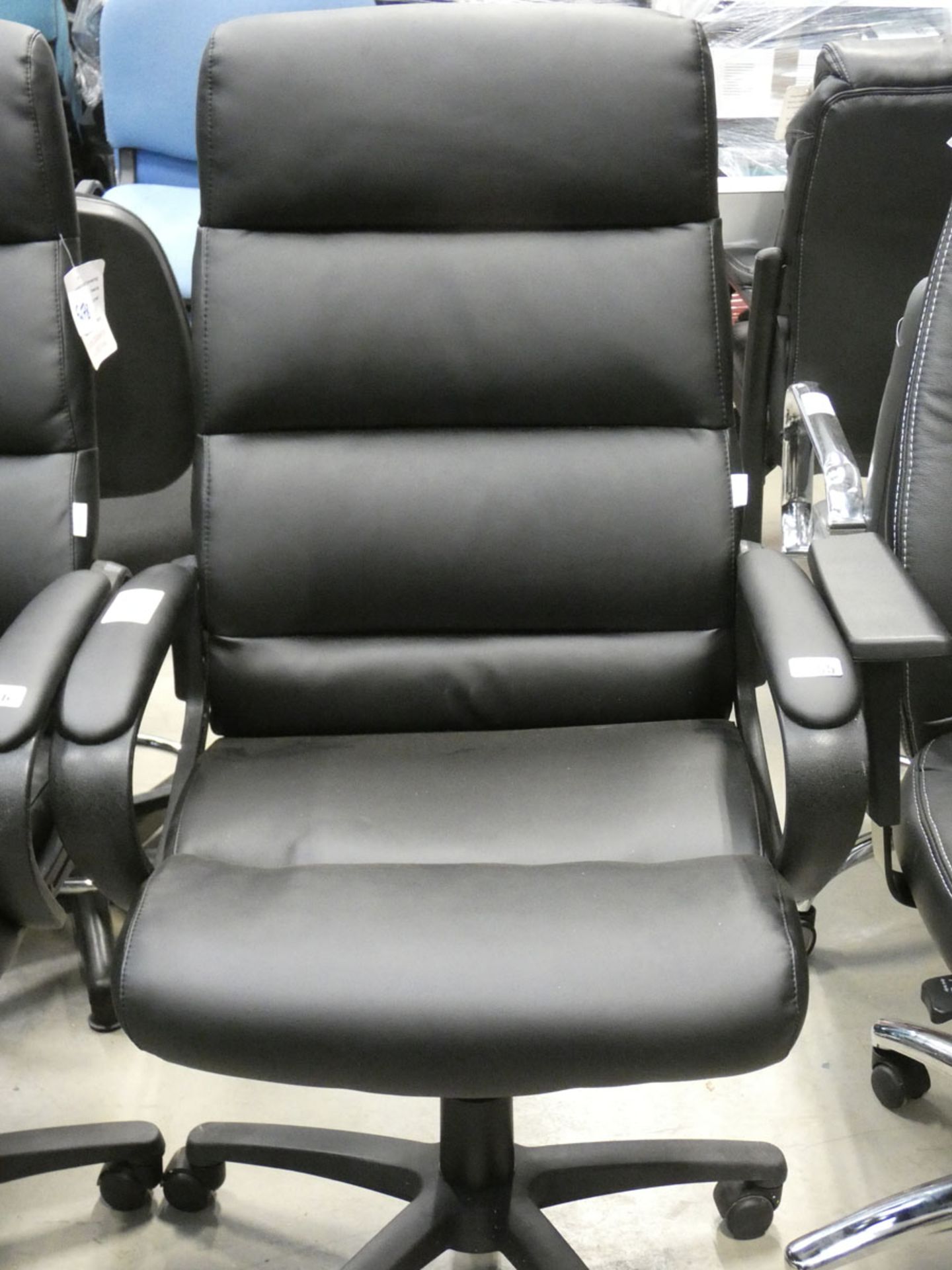 A black high back swivel armchair