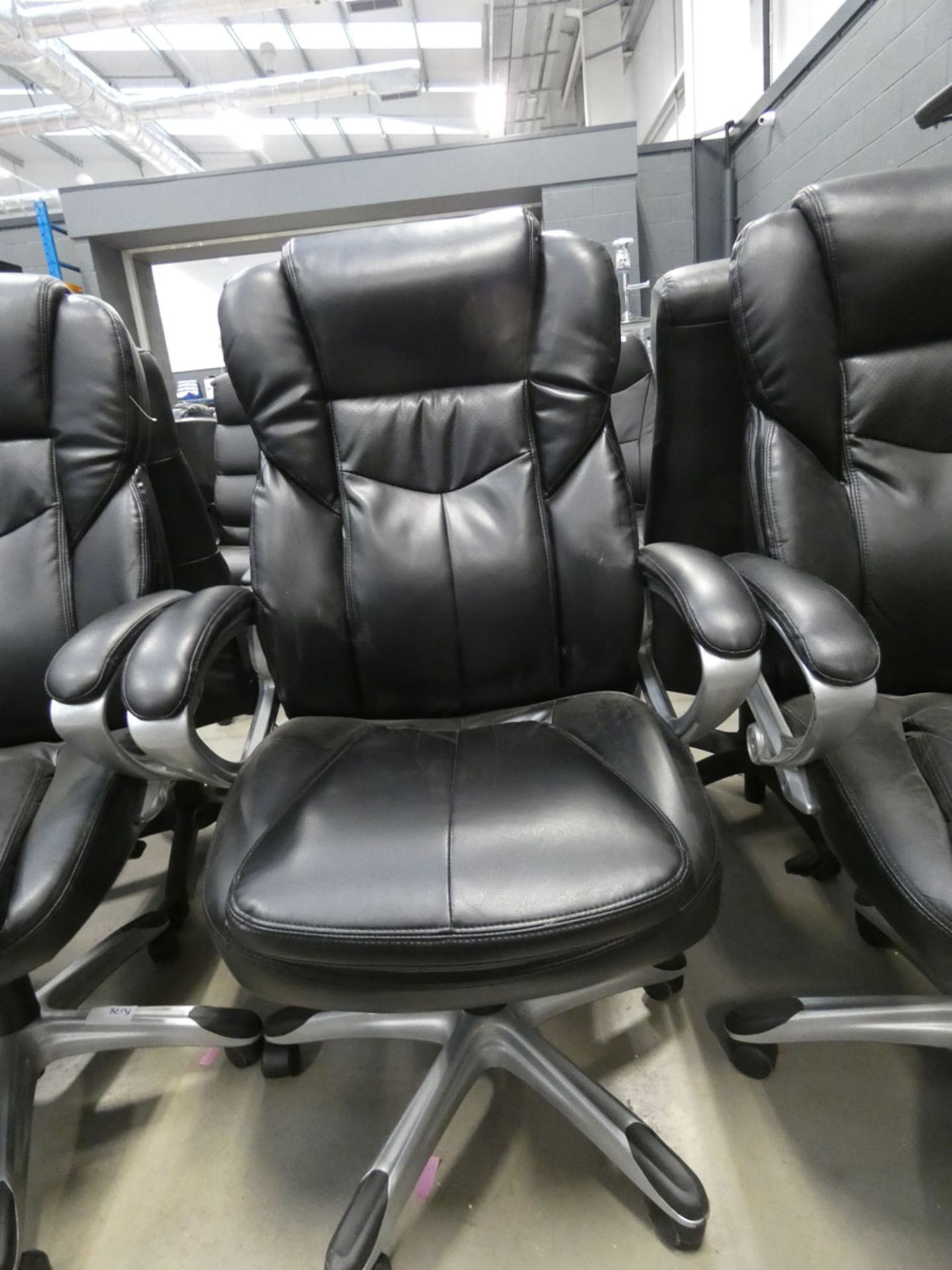 A black high back swivel armchair