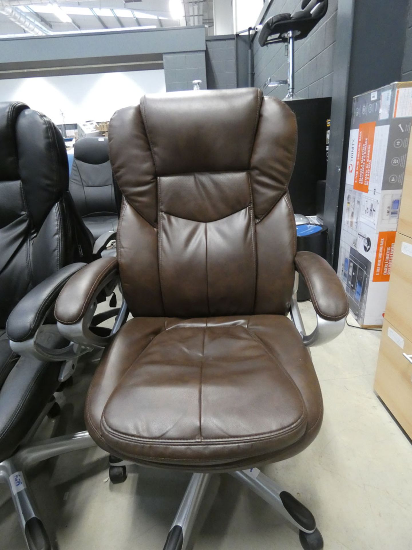 A brown high back swivel armchair