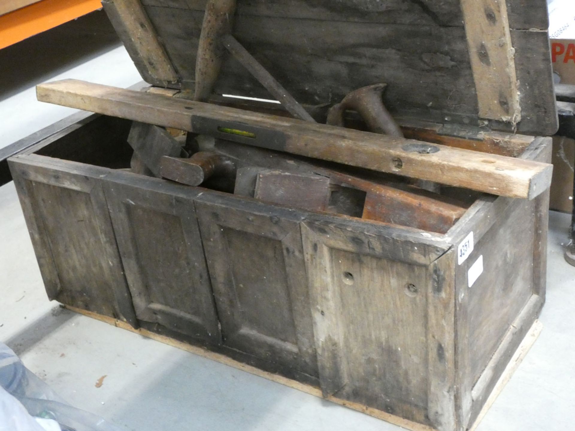 A wooden tool box of vintage carpenter's tools