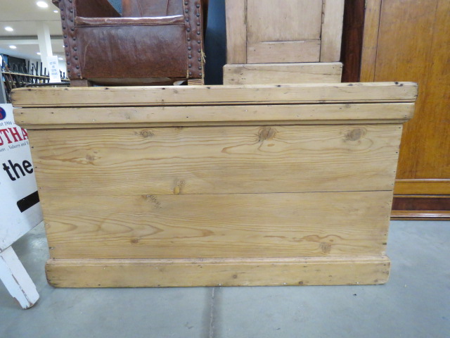 A stripped pine blanket box