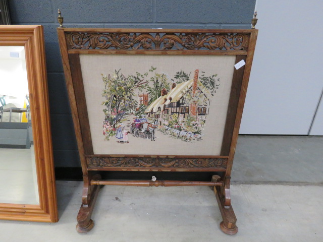 Heavily carved Victorian fire screen, with embroidered insert