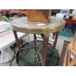 A circular brass tray table